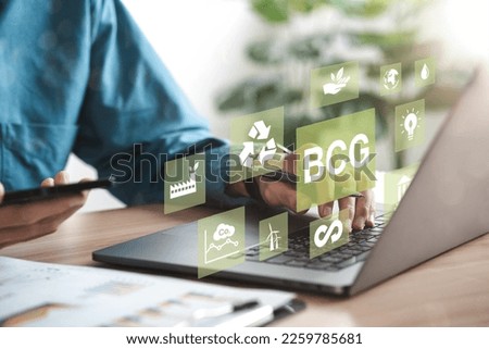 Businessman using computer to study BCG for sustainable economic development. BCG concept, bioeconomy, circular economy, green economy. with an icon on the screen