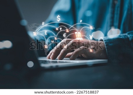 Businessman using computer virtual screen  with central banking and international currency include dollar Yuan Yen Pound sterling and Euro for forex and currency exchange money transfer concept.