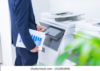 Businessman Using A Copy Machine