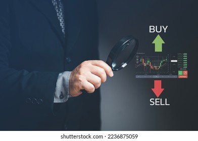 Businessman using data analysis tools to approve and make decisions in stock trading. Magnifier tool. Stock trading strategy. Stock market. Cryptocurrency.