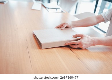 Businessman using data folder paper work siting on table in modern home office 