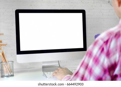 Businessman Using A Desktop Computer With A View Over His Shoulder From Behind Of The Blank Screen Of The Monitor.