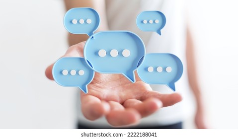 Businessman using digital blue speech bubbles talk icons. Minimal conversation or social media messages floating over user hand. 3D rendering