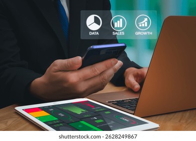 Businessman using digital data analytics interface and financial dashboard on tablet and laptop in  office