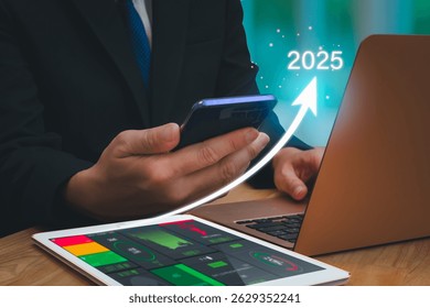 Businessman using digital data analytics interface and financial dashboard on tablet and laptop in  office