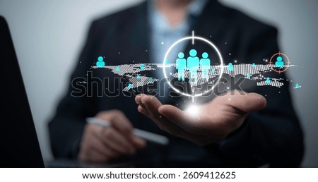 Businessman using digital interface for global customer targeting and audience segmentation strategy with futuristic network data visualization