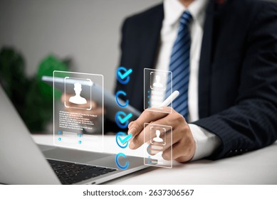 Businessman using digital interface to select candidates with virtual profile icons and checkmarks, representing modern recruitment, HR human resources technology, and hiring process.