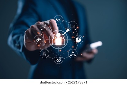 Businessman using digital interface to target customers. Marketing strategy, customer relationship management (CRM), data analytics and business growth through technology.