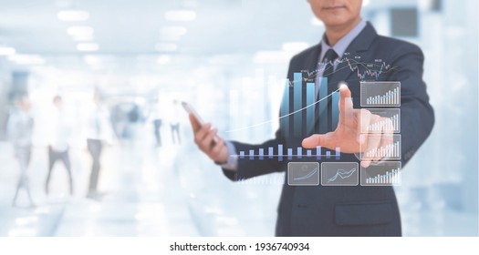 Businessman Using Digital Tablet Analysing Financial Data, Market Report, Economic Growth Graph Chart On Virtual Screen. Business Strategy Analysis, Digital Marketing Plan, Business And Technology 