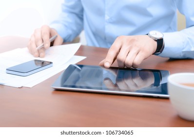 Businessman using digital tablet computer with modern mobile phone. New technologies for success workflow concept.