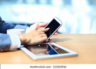 Businessman using digital tablet computer with modern mobile phone. New technologies for success workflow concept.