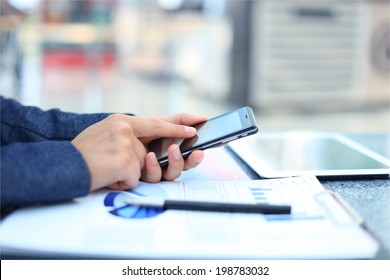 Businessman using digital tablet computer with modern mobile phone
