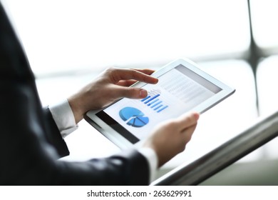Businessman using digital tablet computer with modern mobile phone