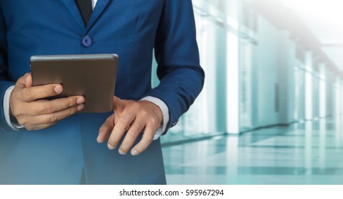 Businessman Using Digital Tablet With Modern Building And Social Media