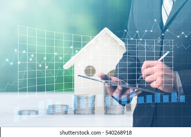 Businessman Using Digital Tablet With Stacking Coins And House Model ,Business Finance And Money Concept,Investment Concept,forex Graph