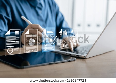 Businessman Using Digital Workflow System with Virtual Documents and Checklist Icons on Laptop and Tablet, Managing Online Reports, Analytics, and Task Completion in a Paperless Office Environment
