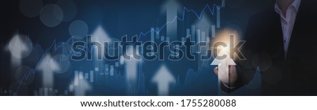 Businessman using finger touch symbol arrow up,stock graph and chart background,concept growth business and investment,Stock market and strategy for making market plan and stock market fluctuations 