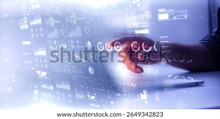 Businessman using futuristic user interface with virtual data analytics. Innovative dashboard with financial charts, graphs, and global network information for business intelligence.