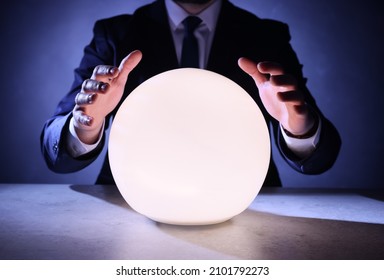 Businessman Using Glowing Crystal Ball To Predict Future At Table, Closeup. Fortune Telling