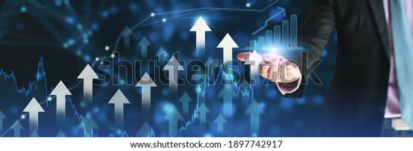 Businessman using holding symbol arrow up,stock graph\
and chart background,concept growth business and investment,Stock\
market and strategy for making market plan and stock market\
fluctuations 
