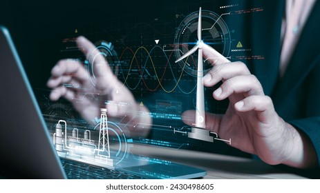 Businessman using laptop with Alternative energy for the future concept,Wind turbines change wind energy into electrical energy, Renewable energy engineer working on a laptop. - Powered by Shutterstock