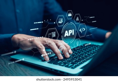 Businessman using laptop with API  icon on a virtual screen in the background of technology device internet, API Application Programming Interface connects services on the internet data communication.