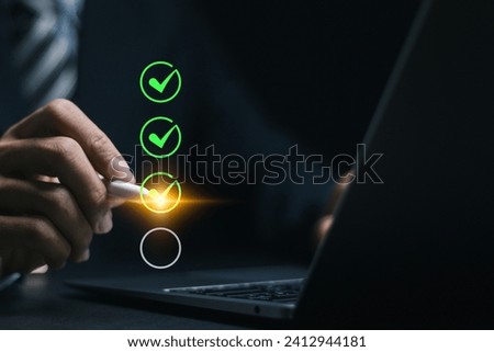 Businessman using laptop, Checking mark on checkboxes for checklist concept. 