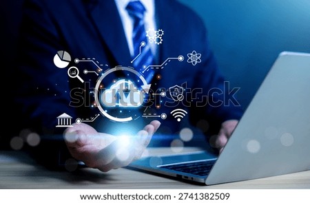 Businessman using laptop with cloud computing technology interface, data storage, cybersecurity, analytics and digital network icons. Concept of cloud service fintech, big data business transformation