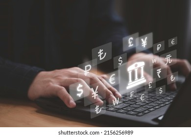 Businessman using laptop computer with central banking icon and currency include dollar yuan yen pound sterling euro and ruble for trading forex money transfer concept.