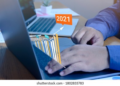 Businessman using a laptop computer with data analytics and statistics information business technology on table top.