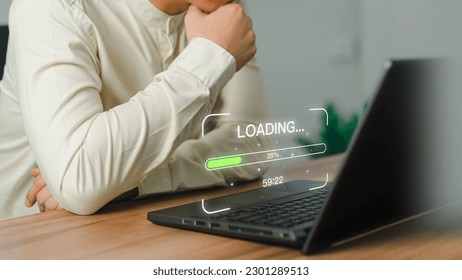 Businessman using a laptop computer for download and update software and waiting to loading digital file data form website, very slow internet form wifi. Concept of waiting for load of loading symbol.