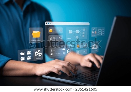 Businessman using laptop computer to manage file document on company server. Cloud backup online documentation and digital storage software. Database download, upload. Permission access application.
