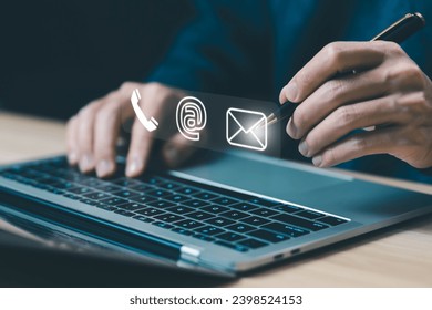 businessman using a laptop to contact customer support shows a contact icon ( address, phone, email, mobile, call ) contact us concept. help from mail websites  digital technology of business service