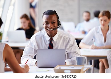 Businessman Using Laptop In Customer Service Department