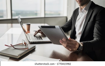 Businessman Using Laptop And Digital Tablet In Office. Men Professional Working On Computer At Home. Business, Internet Marketing, Freelance, Studying, Journalism Distance Work Concept.