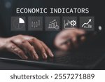 Businessman using laptop with economic indicators icon on virtual screen, Economic indicators concept. GDP growth, inflation rate, unemployment rate, stock market performance, and consumer confidence