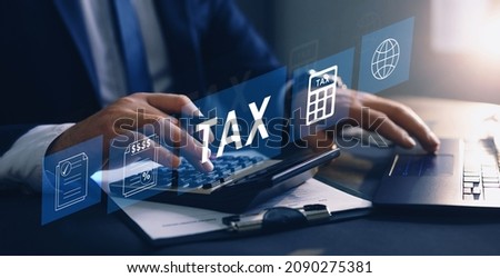 Businessman using the laptop to fill in the income tax online return form for payment.
Financial research,government taxes and calculation tax return concept. Tax and Vat concept.