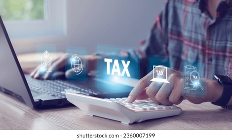 Businessman using laptop to fill out online tax return form to pay Financial research, government taxes, and tax return calculation concepts. - Shutterstock ID 2360007199