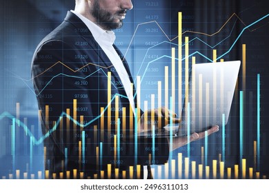 Businessman using a laptop with financial graphs and data overlay on a dark background. Concept of trading, investing, and market analytics - Powered by Shutterstock