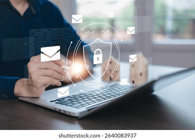 A businessman using a laptop with floating email icons and a cybersecurity shield symbol. Concept of email security, phishing threats, spam protection, and cybercrime prevention in the digital world.