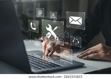 Businessman using laptop with helpdesk icon on screen, Hotline assistance service available by phone, chat, email, Technical support customer service concept.