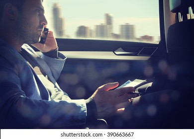 Businessman using laptop in his car