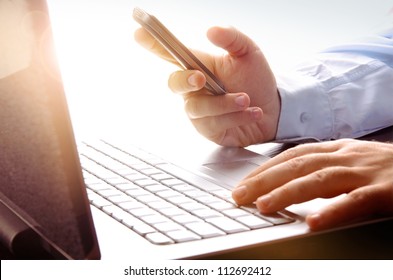 Businessman Using  Laptop And Mobile Phone