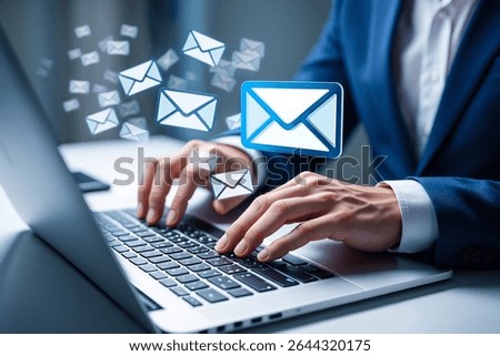 Businessman using laptop, receiving multiple emails; digital communication concept.