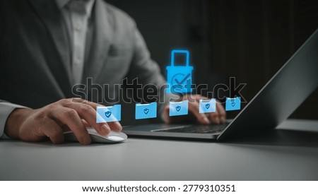 Businessman using laptop with secure data protection system and encrypted digital folders for cybersecurity, privacy management, cloud storage security and information safety.