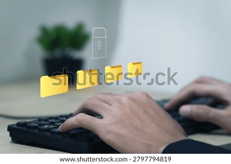 Businessman using laptop with secure data protection system and encrypted digital folders for cybersecurity, privacy management, cloud storage security and information safety.