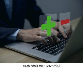 Businessman using laptop show plus and minus signs. Concept of opposites, decisions, and uncertainty. Positive or Negative Business Choices Analysis of advantages and disadvantages Comparison