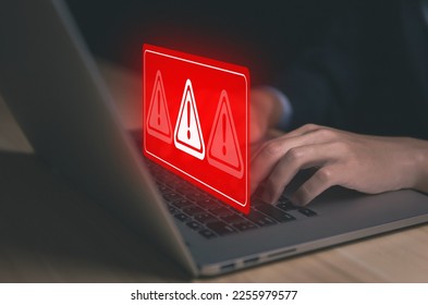 Businessman using laptop showing warning triangle and exclamation sign icon Warning of dangerous problems Server error. Virus. Maintenance concept. caution internet technology network security - Shutterstock ID 2255979577