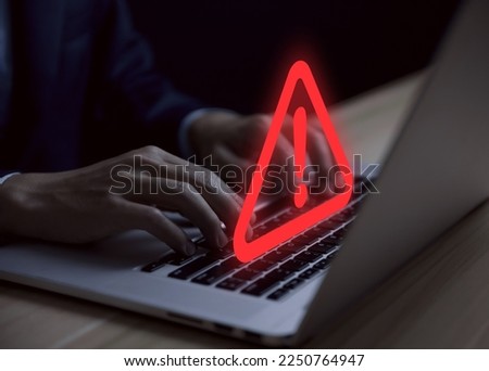 Businessman using laptop showing warning triangle and exclamation sign icon Warning of dangerous problems Server error. Virus. Maintenance concept. caution internet technology network security