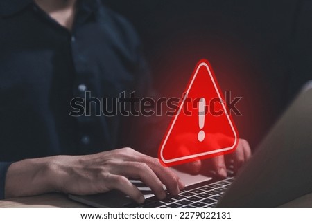 Businessman using laptop showing warning triangle and exclamation sign icon Warning of dangerous problems Server error. Virus. Maintenance concept. caution internet technology network security